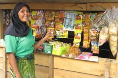 Image: Zainab is proud of her small store, which was made possible by a cash grant from Oxfam. Now we can be independent, she says. Credit: Hilman Agung/Oxfam