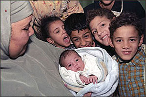 Samah and her newborn daughter, Basant, surrounded by her other children