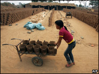 A girl works in a brick kiln in China