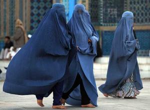 Afghan women wearing burqas. Critics say President Hamid Karzai rushed through discriminatory legislation to appease fundamentalists