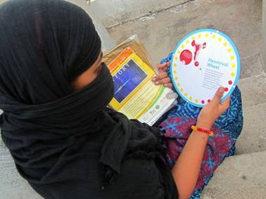 Nasreen Jehan, a high school student in eastern India, studies a leaflet on menstrual hygiene. Credit: Stella Paul/IPS