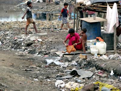Slum dwellers live surrounded by dirty stagnant water, garbage and overflowing drains - 