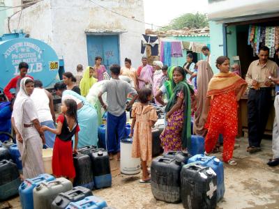 Safe water is scarce - people have to walk to fetch water or queue to collect it from tankers - 
