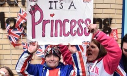 Royal fans celebrate the birth of Kate and Williams daughter, outside St Marys hospital in London.